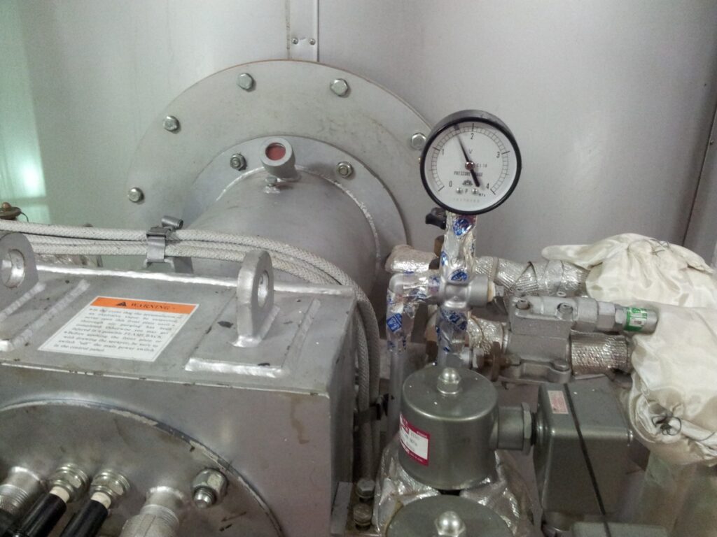 Marine boiler burner front showing fuel oil pressure gauge onboard ship